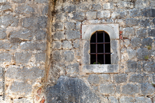window with bars in the old wall, background © Дмитрий 