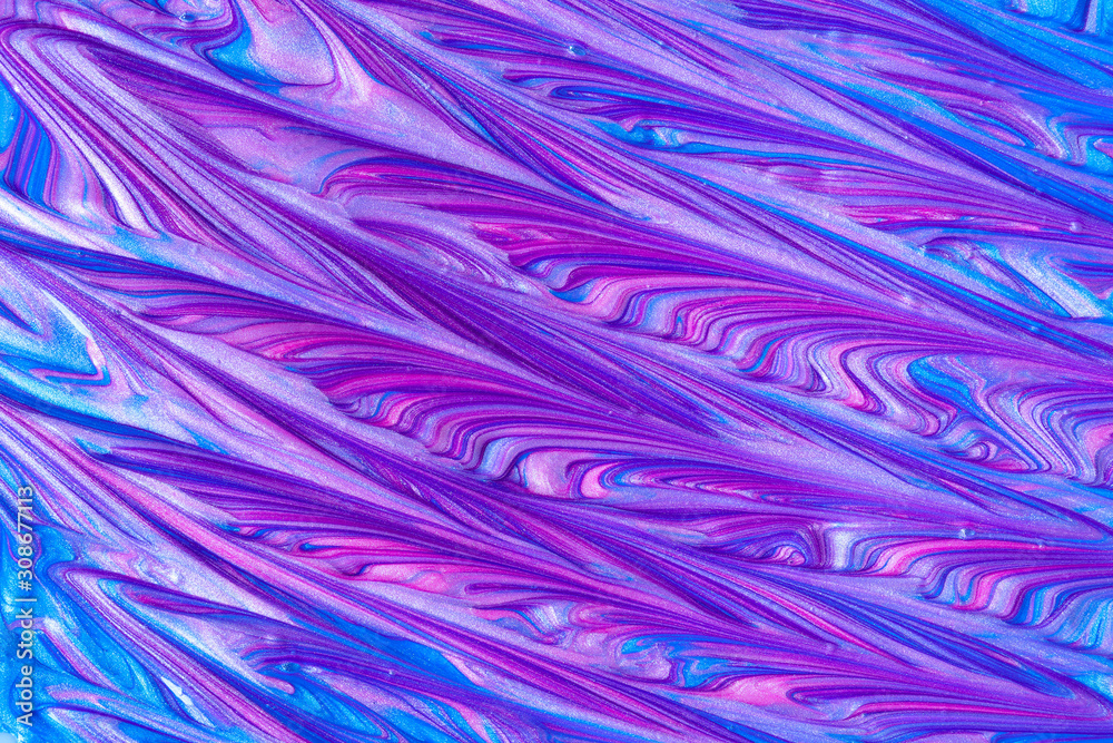 Close up liquid luxury blue and pink metallic glitter paint swirls to make an abstract textured background