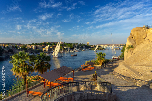 Beautiful landscape with felucca boats on Nile river in Aswan at sunset, Egypt