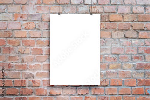 Poster design presentation mockup. Blank paper poster hanging attached with clips across brick wall