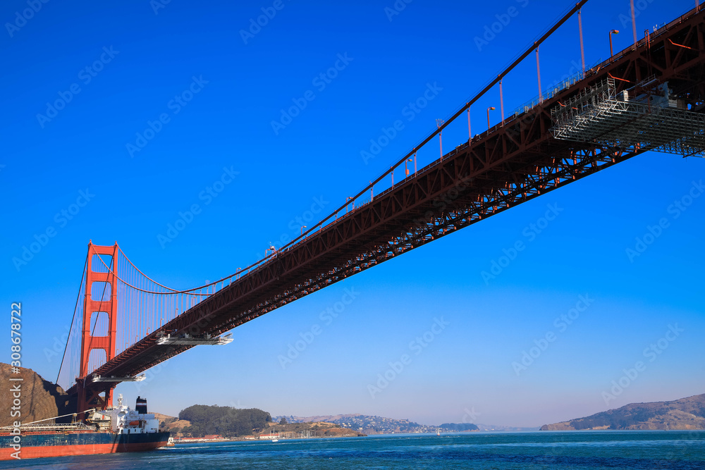 Fototapeta premium Golden Gate Bridge with cargo ship, San Francisco, California, USA
