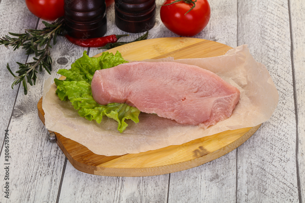 Raw Turkey steak served rosemary