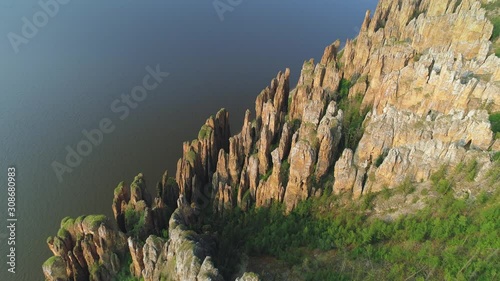 Lena pillars unique vertical cliffs epic rock national park Yakutia Russia miracle natural monument cinematic landscape Lena riverWorld Heritage travel sight. Summer day. Aerial approach photo