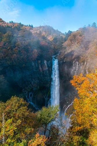 View of Kegon Waterfall at the cliff of colorful foliage of autumn season forest on the mountain in Nikko City, Tochigi Prefecture, Japan. © takepicsforfun
