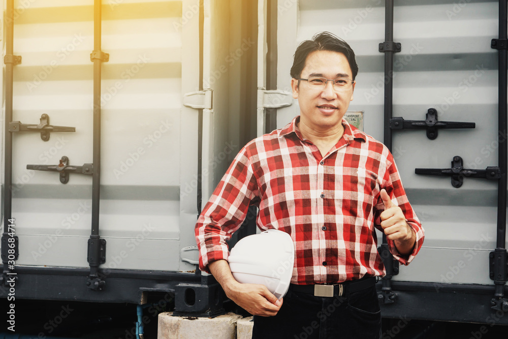 Obraz premium Engineer or worker or business man showing thump up hands symbol and white safety helmet.