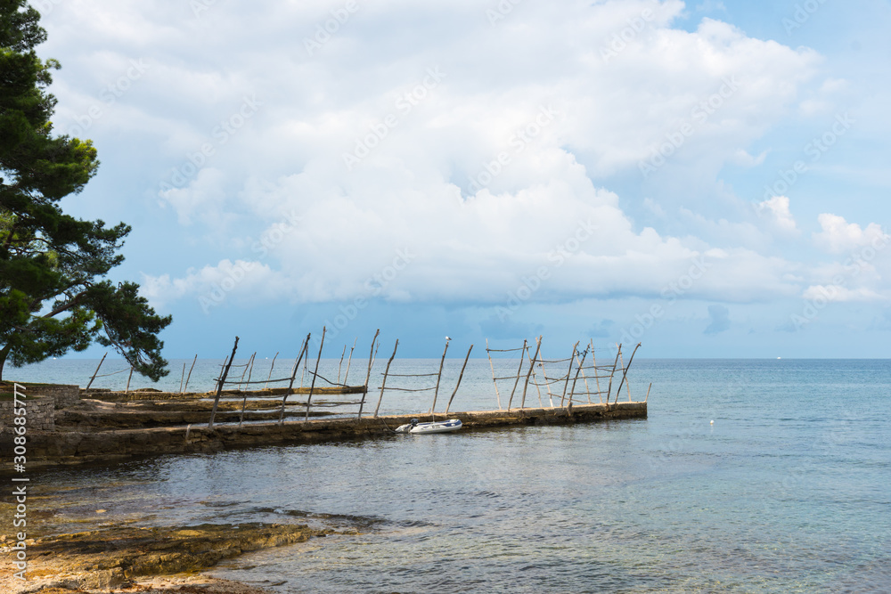 Inflatable dinghy tied to the small dock of Savudrija, Croatia