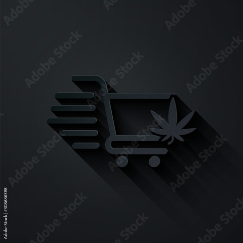 Paper cut Shopping cart with marijuana or cannabis leaf icon isolated on black background. Online buying. Delivery service. Supermarket basket. Paper art style. Vector Illustration