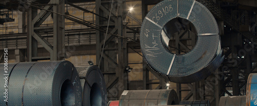 Industrial metal sheet coils connected with metal sheet profile forming machine.