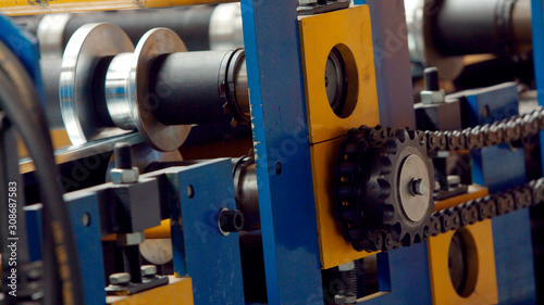 Steel cog gear set of metal sheet bending machine in metalwork factory.