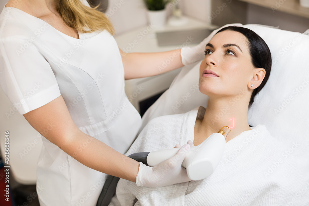 Fototapeta premium Hardware cosmetology. Skin remodeling. Laser resurfacing of wrinkles, scars and solar damage to the skin in a cosmetology clinic.