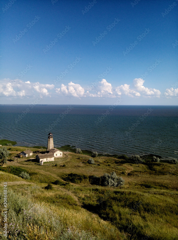 beautiful field scenery of the sea clouds and lighthouse dalik