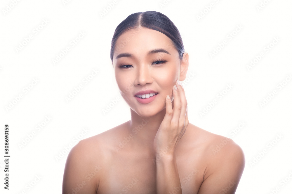 Beautiful Young Asian Woman with Clean Fresh Skin isolate on white background. Spa, Face care, Facial treatment, Beauty and Cosmetics concept. Right hand touch jaw. Smile with teeth. Beautiful Young Asian Woman with Clean Fresh Skin isolate on white background. Spa, Face care, Facial treatment, Beauty and Cosmetics concept. Right hand touch jaw. Smile with teeth.