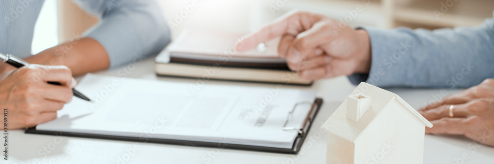 broker agent and customer holding pen, the policyholder and explain discussing for concerning mortgage loan offer for and house insurance. broker agent and customer holding pen, the policyholder and explain discussing for concerning mortgage loan offer for and house insurance.
