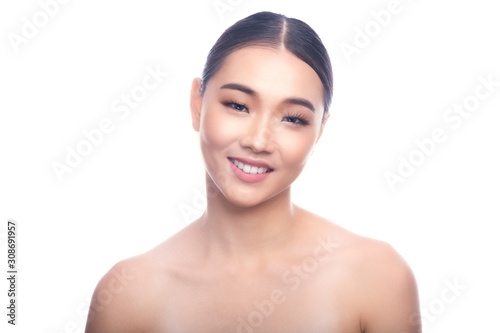 Beautiful Young Asian Woman with Clean Fresh Skin isolate on white background. Spa, Face care, Facial treatment, Beauty and Cosmetics concept. Head on left, big smile.