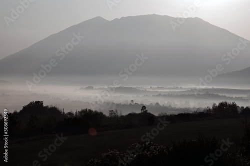 Принти на полотні beautiful valley below mountain under morning sun rays