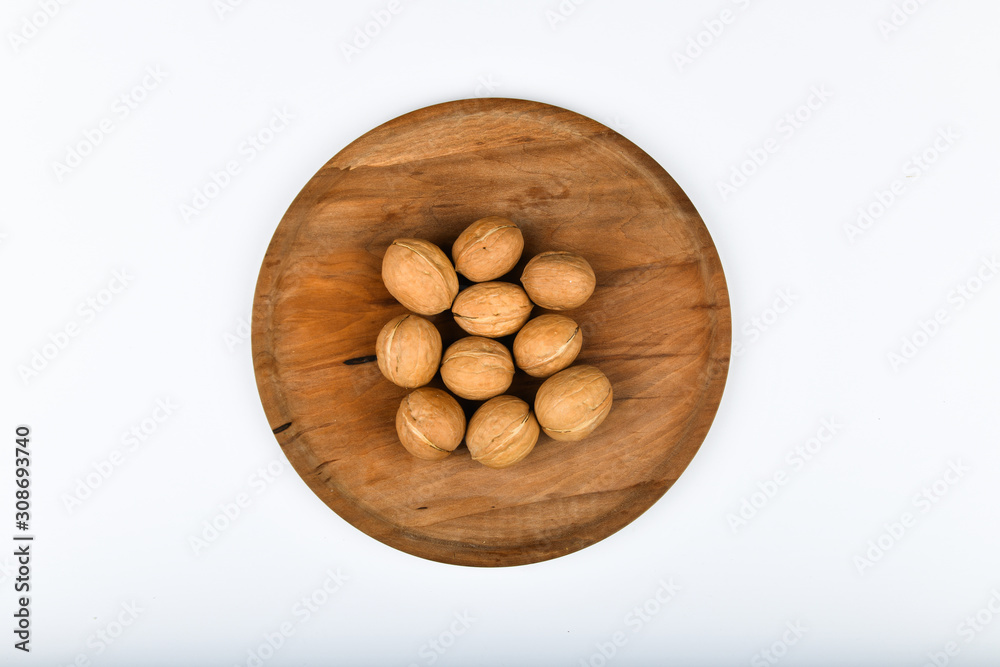 walnuts on wooden utensils. Close up view of walnuts. Walnuts are 4 water, 15 protein, 65 fat and 14 carbohydrates, including 7 dietary fiber. In a reference portion of 100 grams. walnuts on wooden utensils. Close up view of walnuts. Walnuts are 4 water, 15 protein, 65 fat and 14 carbohydrates, including 7 dietary fiber. In a reference portion of 100 grams.