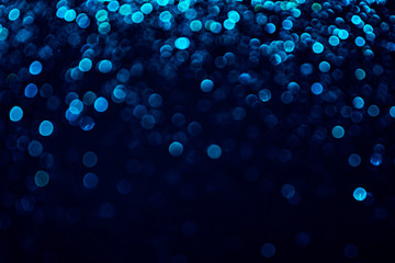 Bright blue glitter raster festive background. Abstract shimmering circles decorative backdrop. Bokeh lights with shiny effect illustration. Overlapping glowing and twinkling spots.