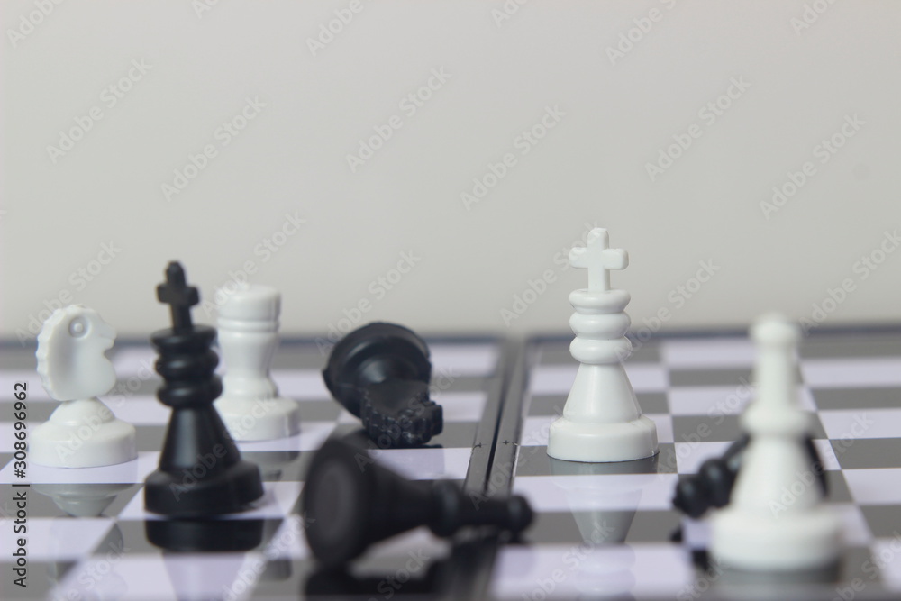 Simple Photo illustration for War, battle or politic situation concept, plastic magnetic small chess, critical situation Simple Photo illustration for War, battle or politic situation concept, plastic magnetic small chess, critical situation