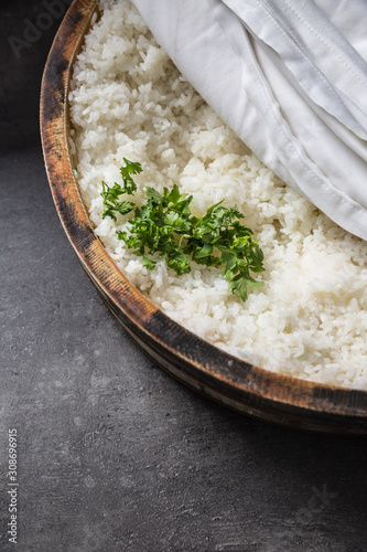 Cooked rice in a typical Japanese wooden vessel hangiri. Pile of rice before ready to prepare sushi photo