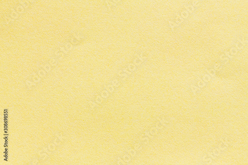Yellow blank piece of paper. A high resolution photo of paper ideal as a background or texture.