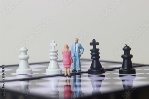 Simple illustration for photo War  Battle or politic situation concept  2 standing mini figure  man and woman negoitation or debate beyond Small Magnetic Plastic chess