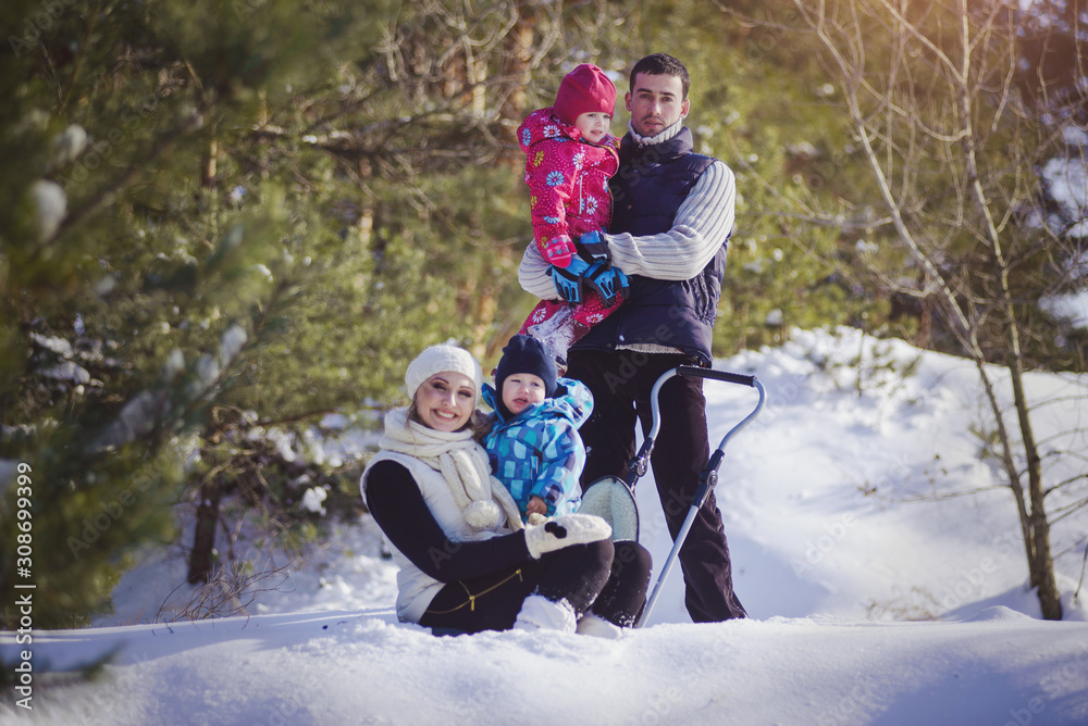 Fototapeta premium Happy family at winter snowy forest