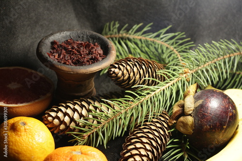 bowl with tobacco for hookah. fruits on a dark background. smoking nargile