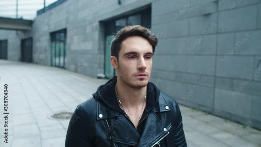 Portrait of hipster man walking street in slow motion. Focused man walking city Portrait of hipster man walking street in slow motion. Focused man walking city