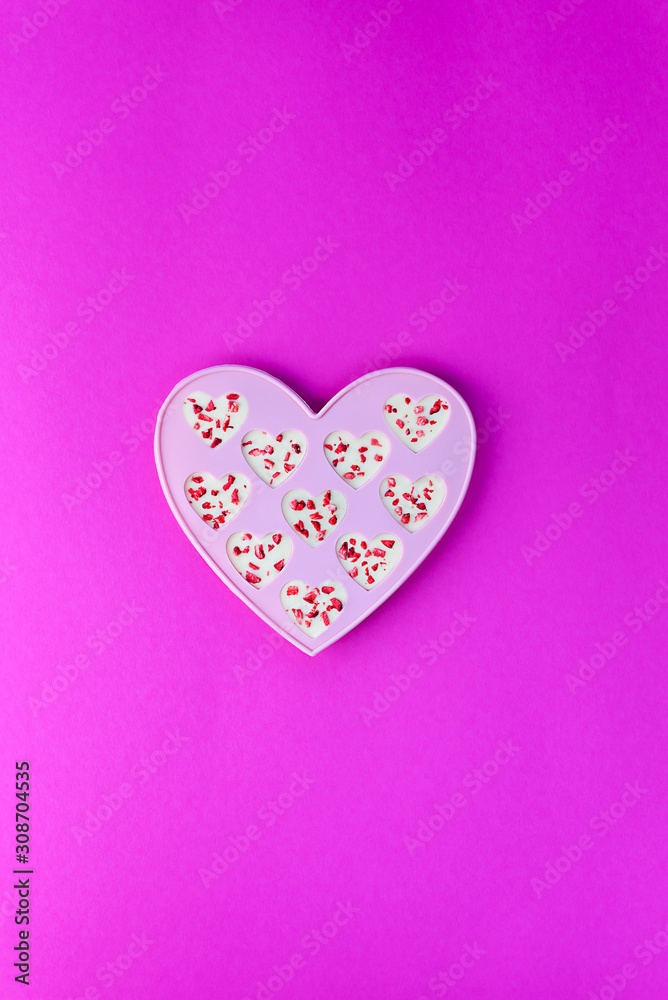 Candy hearts made of white chocolate and sublimated strawberries on a pink background. Valentine's Day.