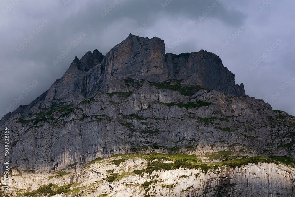 Dark rocky mountain. Switzerland. High Alps mountains. Severe alpine landscape.