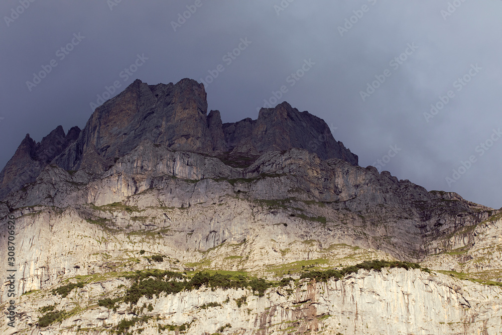 Fototapeta premium High peak of rocky mountain. Scenic alpine landscape in evening sky. Switzerland