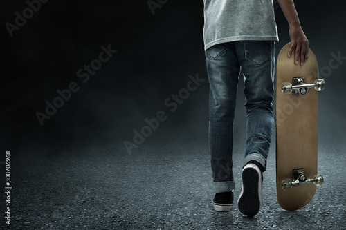 Man holding skateboard on the street