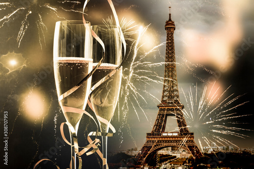 two glasses of champagne and Eiffel tower with fireworks New Year in Paris photo