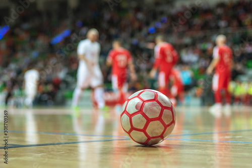 Close up of ball iwith players in the background.