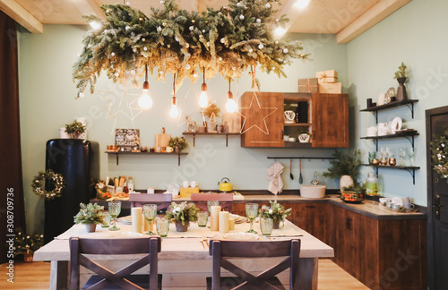 Festive interior in Christmas decorations. modern living room or dining room. Beautiful New Year decorated classic home interior. 