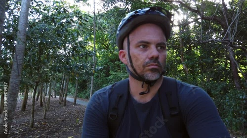 guy riding bike on a footpath slow motion  close up b photo