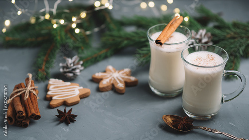 Traditional winter and Christmas drink egg nog in beautiful glass cups and ginger homemade cookies photo