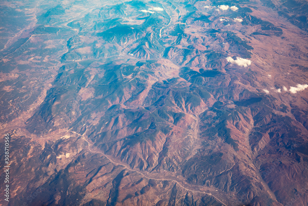 Mountain surface of the earth. Top view of the Earth. View of the mountains from the plane
