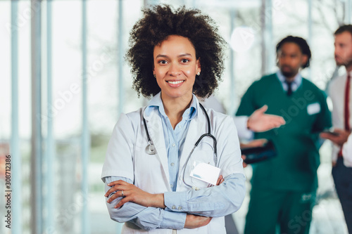 Portrait of african american female doctor on hospital looking at camera smiling.