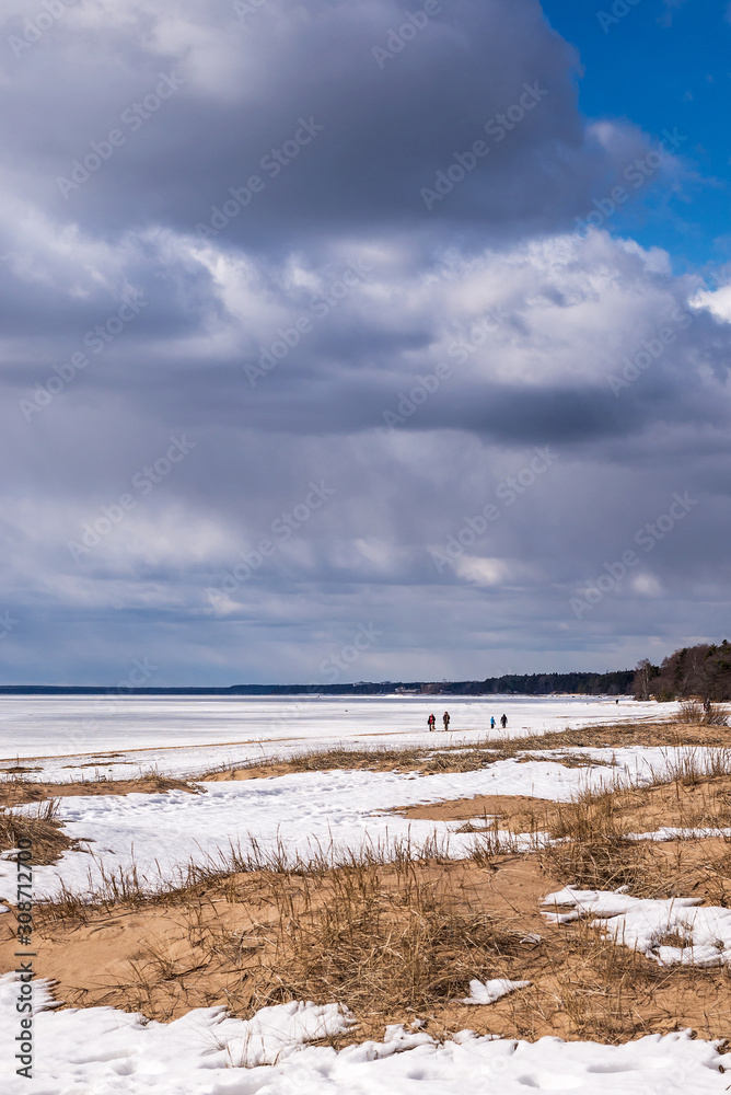 walking along the shore of the frozen Bay under storm clouds walking along the shore of the frozen Bay under storm clouds