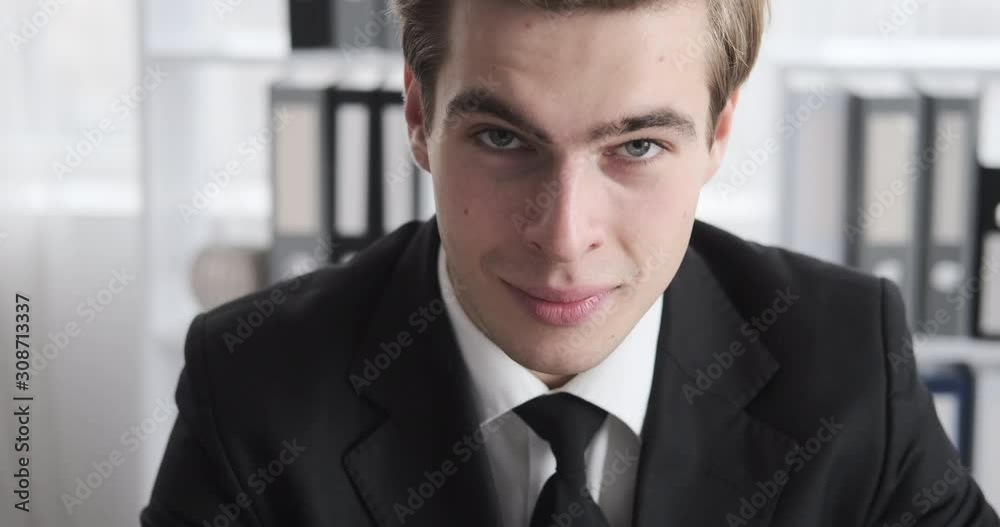 Handsome young businessman smiling at office Handsome young businessman smiling at office