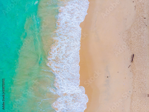 White sand beach turquoise sea wave aerial view copy space