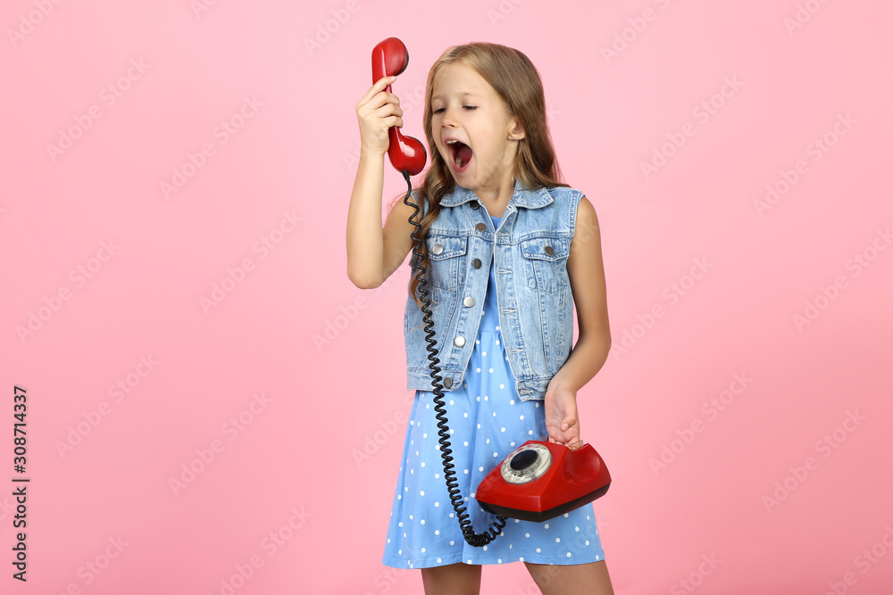 Beautiful little girl screaming in handset on pink background Beautiful little girl screaming in handset on pink background