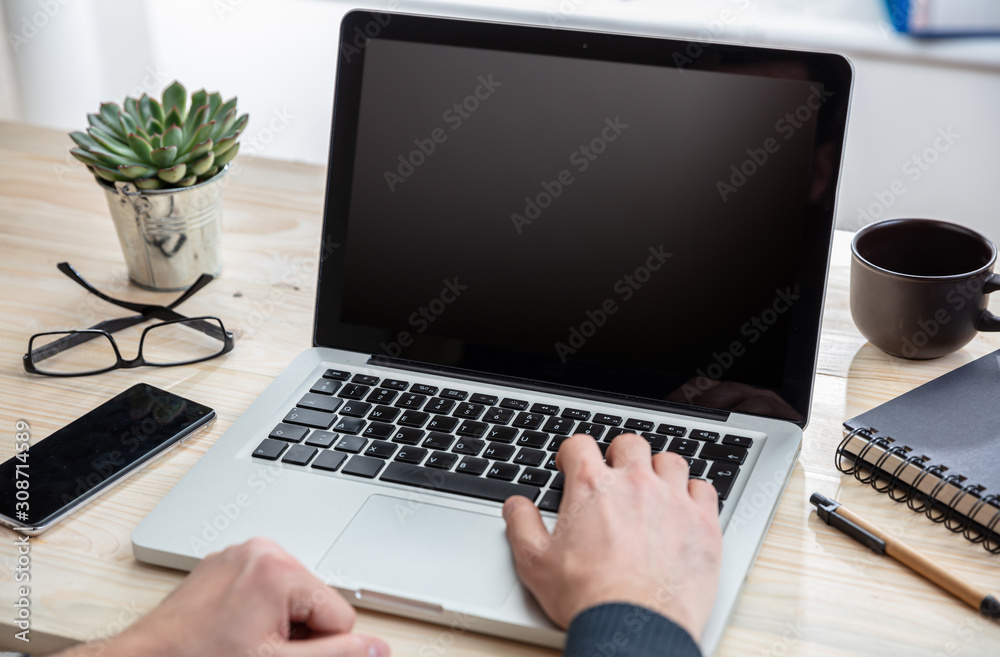Laptop with black blank screen on a wooden desk Laptop with black blank screen on a wooden desk