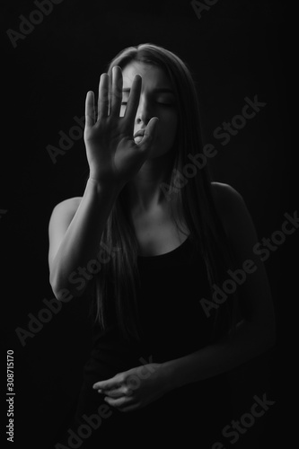  girl with her eyes closed, extended her palm forward, stop emotion