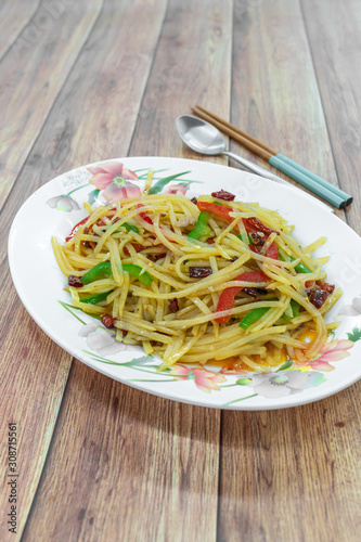 Traditional China Sichuan Chinese home cooking : Stir-fried shredded potato with green red pepper. Vegetable dish, sour and spicy taste, potato crisp and delicious.