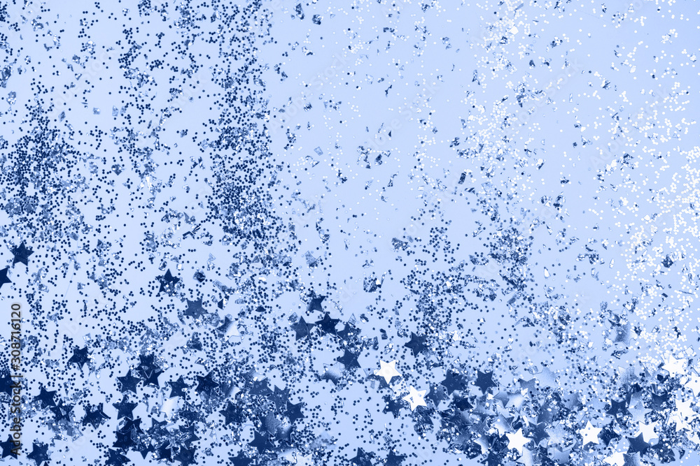 confetti and stars and sparkles on Classic Blue Christmas background. Top view, flat lay. Copyspace for text. Bright and festive holiday background. Color of year 2020. confetti and stars and sparkles on Classic Blue Christmas background. Top view, flat lay. Copyspace for text. Bright and festive holiday background. Color of year 2020.