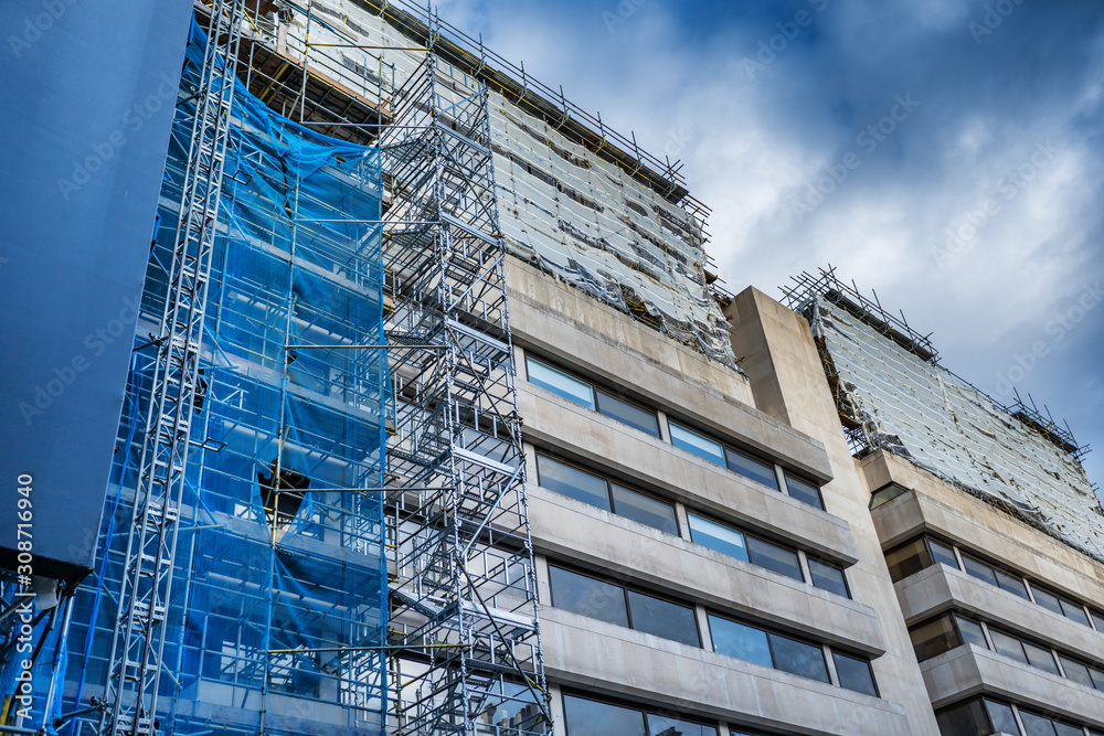 Fototapeta premium scaffolding on building facade for restore, repair and renovate