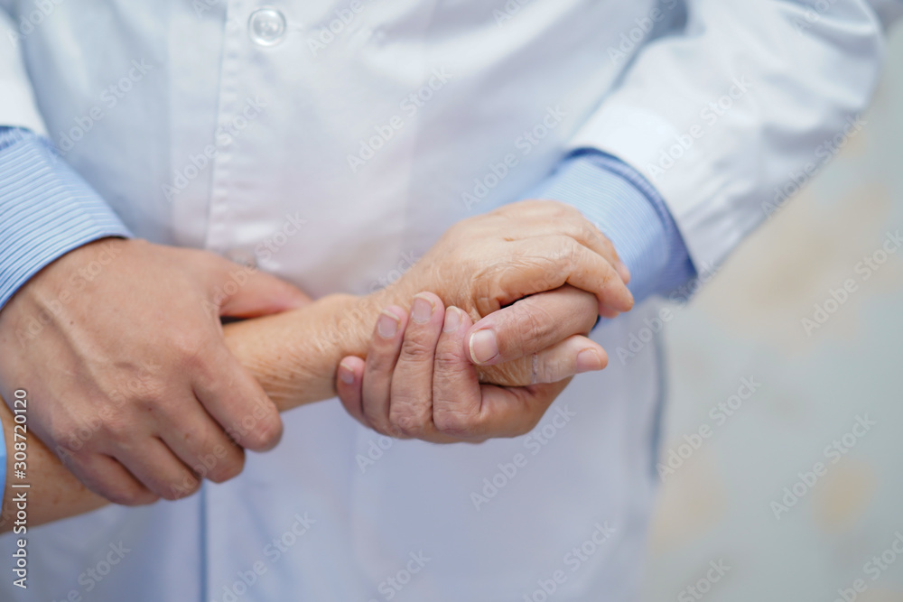 Fototapeta premium Holding Touching hands Asian senior or elderly old lady woman patient with love, care, helping, encourage and empathy at nursing hospital ward : healthy strong medical concept .