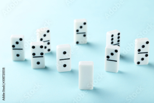 Leader concept. Domino tiles on blue background